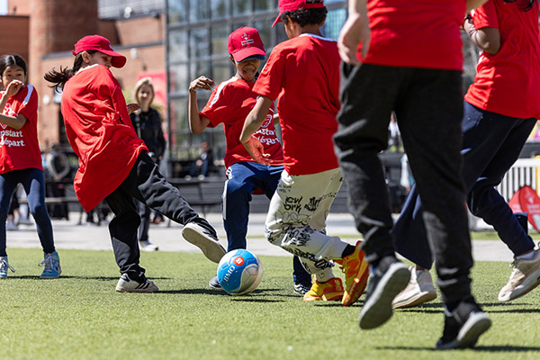 Kids playing soccer on the pitch