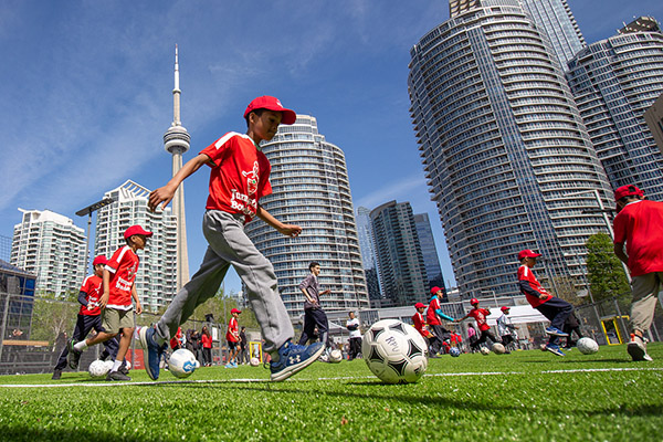 Kids playing soccer on the pitch