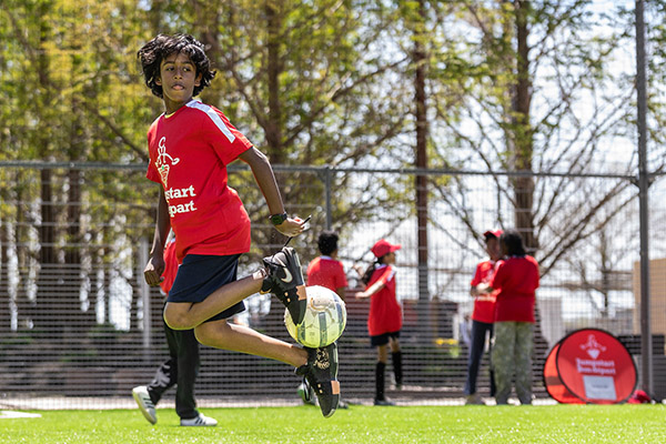 Kids playing soccer on the pitch