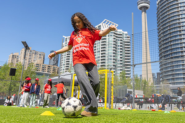 Kids playing soccer on the pitch