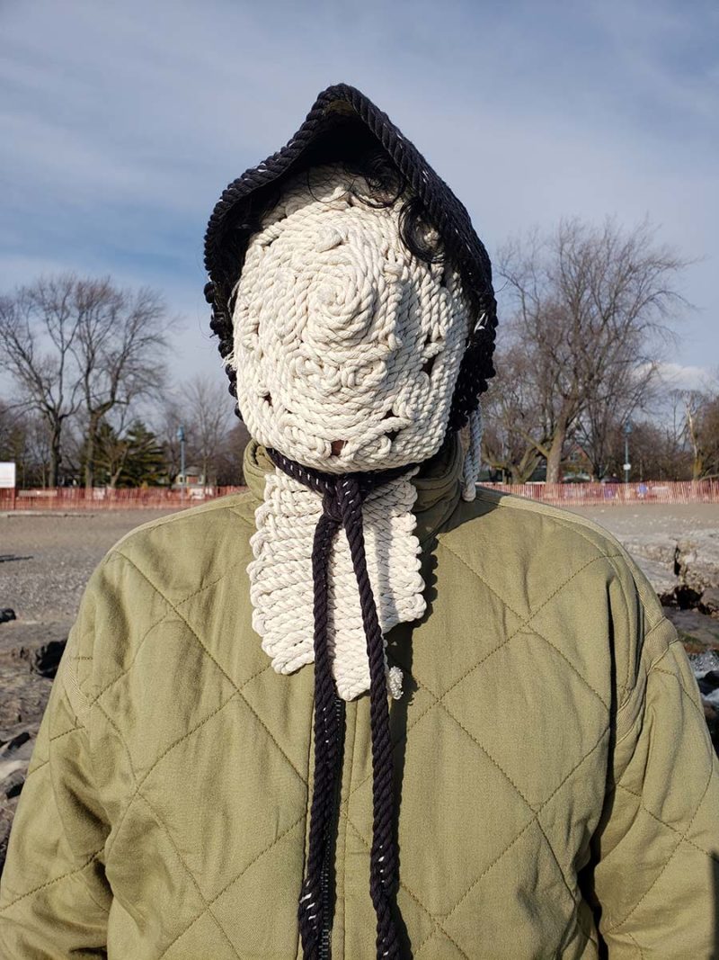 figure with a knit mask covering face