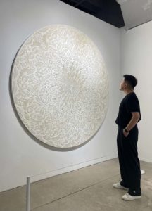 person looking at art on the wall