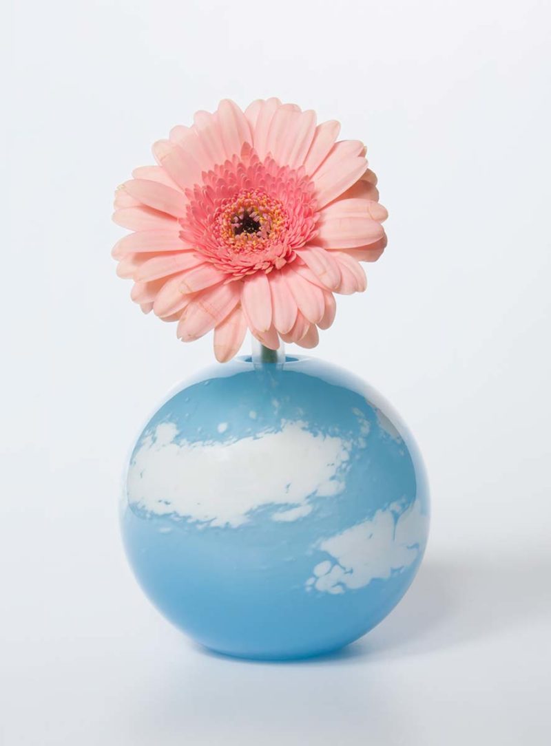 pink flower in a blue vase