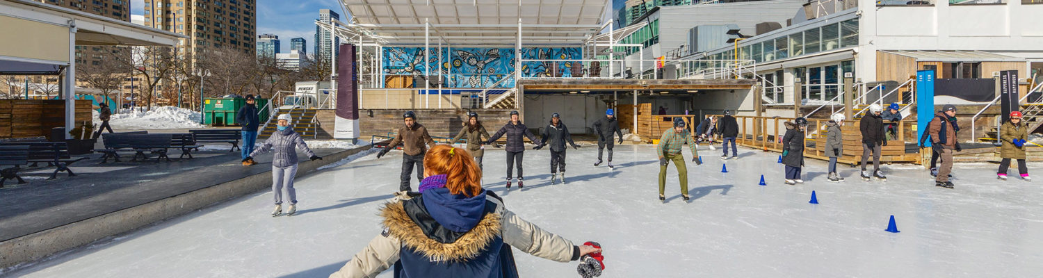 adults skating on ice outdoors