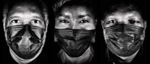 three people wearing masks