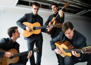 four men playing guitar