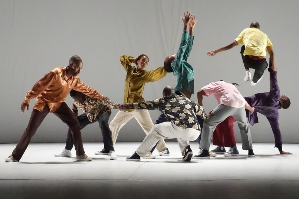 Dancers in colourful clothes in dynamic poses