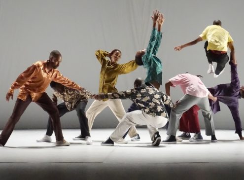 Dancers in colourful clothes in dynamic poses