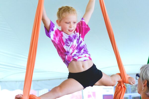 Young girl performing circus acrobatics at a camp