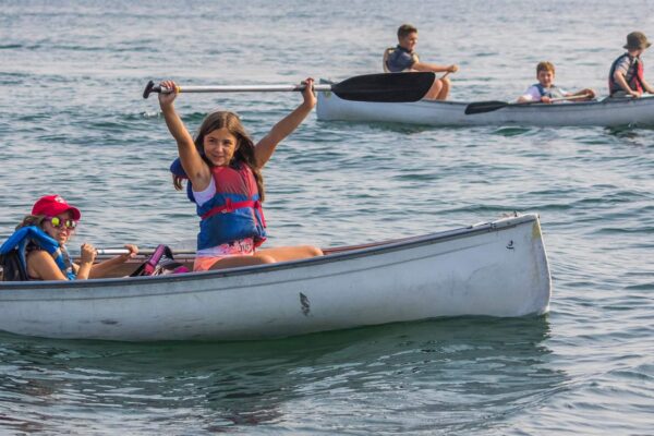 A group of kids canoeing on Lake Ontario