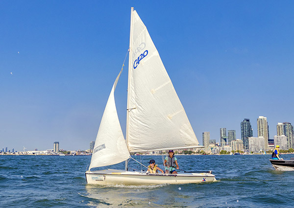 kids on a sailboat on the lake off Toronto