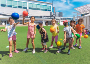 A group of kids playing with balls