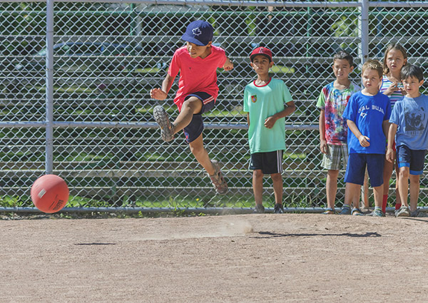 Kids kicking around a play ball