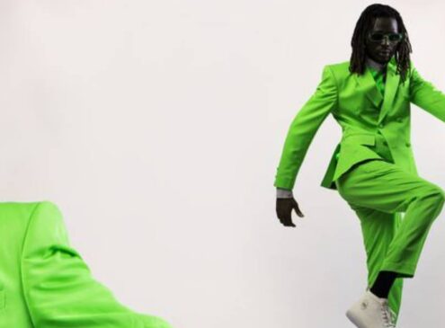 Afro male artist in a lime green suit.