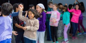 A group of students dancing in a classroom