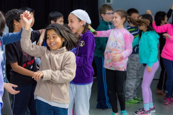 A group of students dancing in a classroom