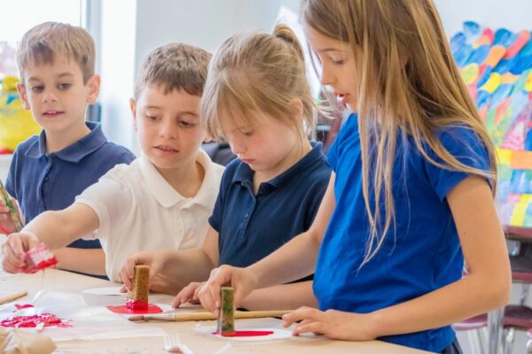 Group of students painting in a classroom