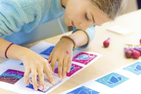 A student works on a craft in a classroom