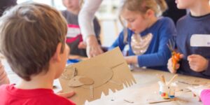 A young student working on a craft in a classroom