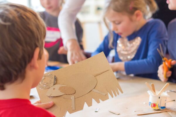 A young student working on a craft in a classroom