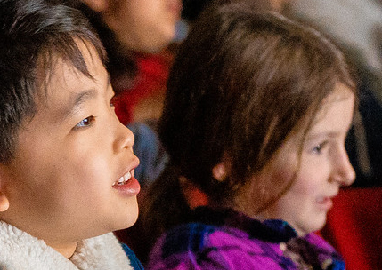 Children watching a performance in a theatre