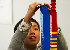Kid building a lego brick tower