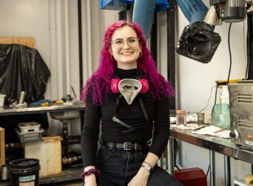 Artist working on glass craft in studio