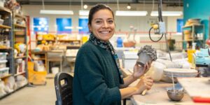 Artist working on ceramic craft in studio