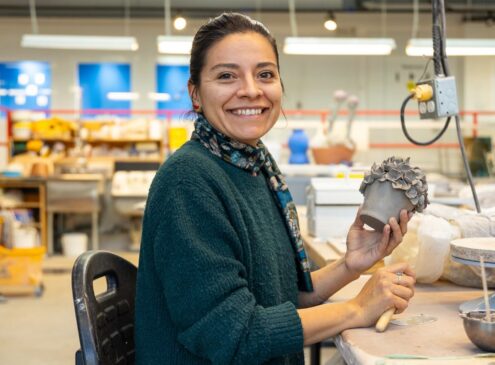 Artist working on ceramic craft in studio