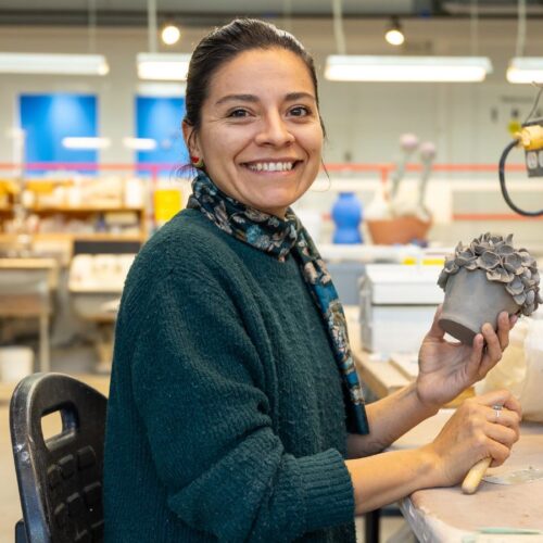 Artist working on ceramic craft in studio