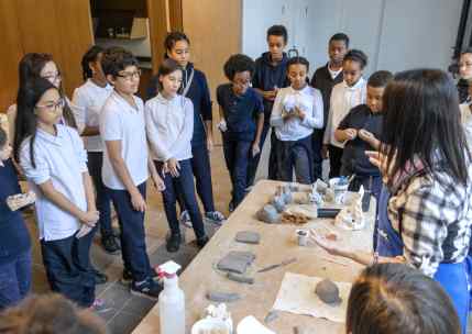 Group of students learning to how make clay sculptures