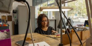 Artist working on metal craft in studio