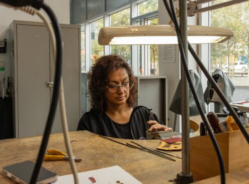 Artist working on metal craft in studio
