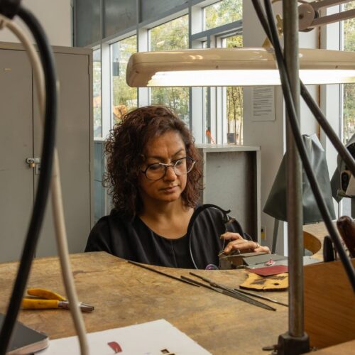 Artist working on metal craft in studio