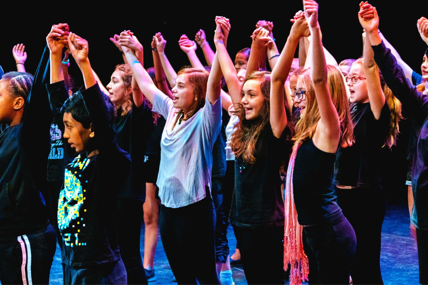 Group of girls doing a theatre performance on stage