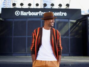 Sean Jones standing in front of an outdoor concert stage