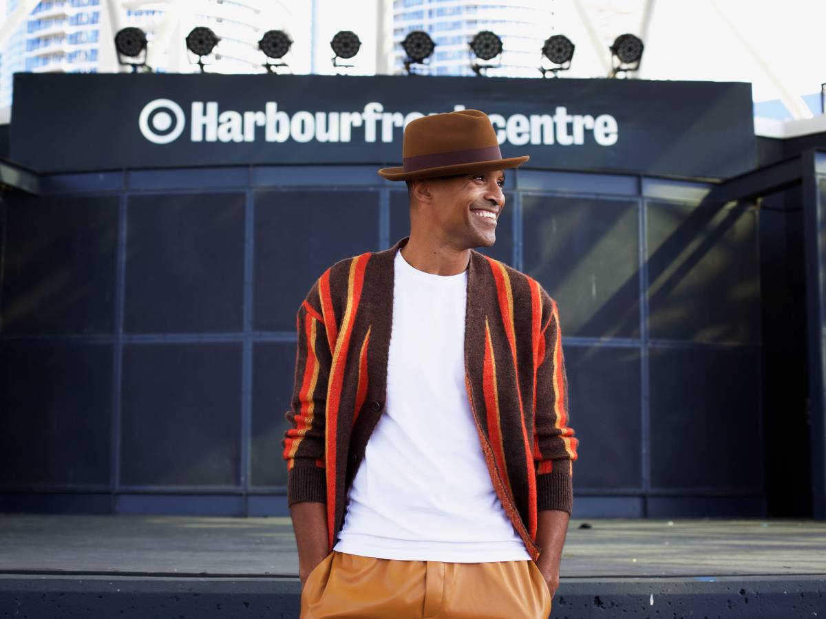 Sean Jones standing in front of an outdoor concert stage