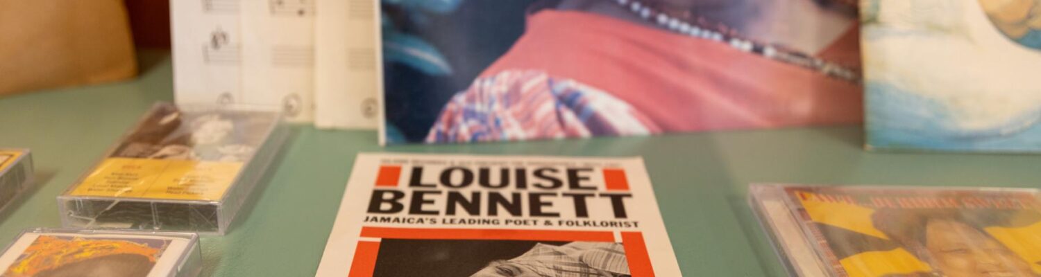 A collection of prints and books of Miss Lou sitting on a table.