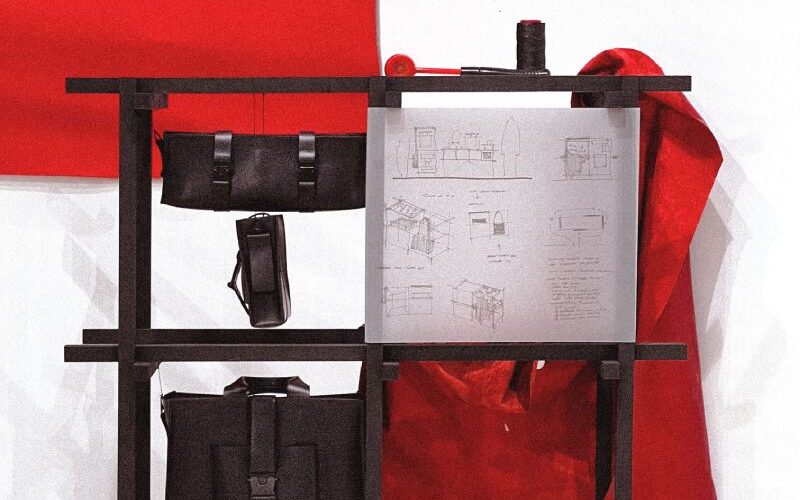 Black bags and paper against red and white background