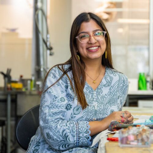 Artist working on textile craft in studio