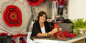 Artist working on textile craft in studio