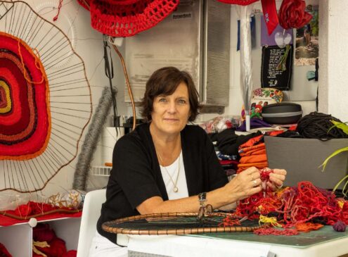 Artist working on textile craft in studio