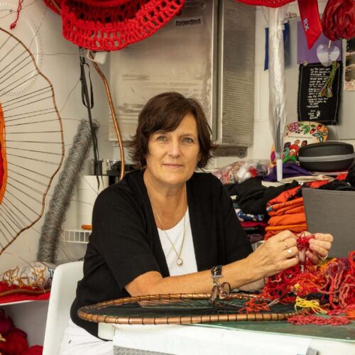 Artist working on textile craft in studio