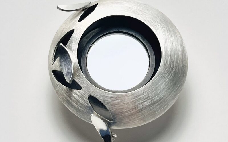 Metal brooch jewellery against white background