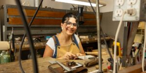 Artist working on metal craft in studio