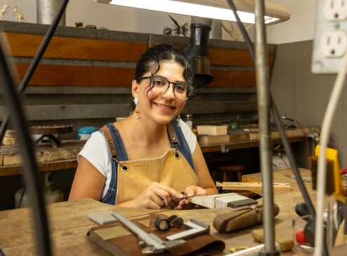Artist working on metal craft in studio
