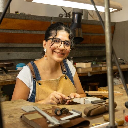 Artist working on metal craft in studio
