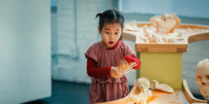 A young girl playing with a science activity indoors