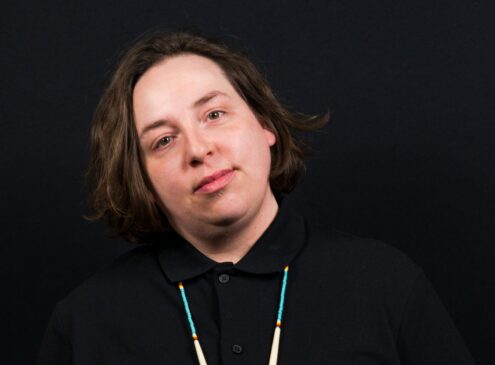 A woman wearing a black shirt and posing for the camera