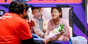 An instructor with two kids playing in an interactive exhibit